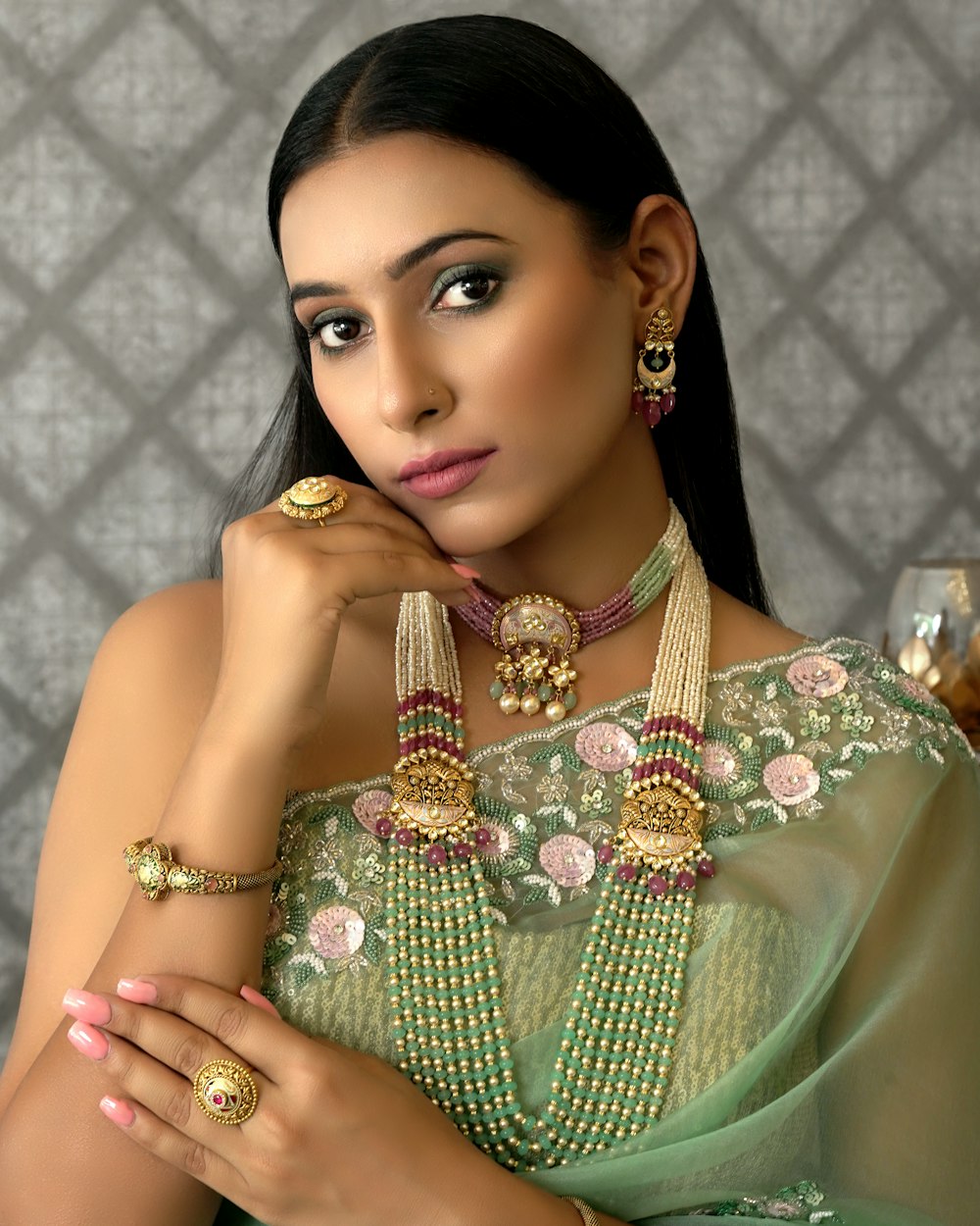 Woman in a green sari with jewellery